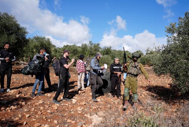 Israeli forces injure Palestinian farmer during raids on olive farms NABLUS, WEST BANK, PALESTINE - OCTOBER 2: Israeli military forces and settlers intervene against Palestinian farmers and international activists harvesting olives in the town of Beita, in Nablus, West Bank, Palestine on October 02, 2026. Israeli settlers beat the 46-year-old Palestinian man in the town of Beita, according to the Palestinian Red Crescent Society. Witnesses told Anadolu that a group of Israeli settlers fired stun grenades and tear gas at farmers in the Jabal al-Arma area, forcing them to leave. Issam Rimawi Anadolu Nablus West Bank. Editorial use only. Please get in touch for any other usage.  Copyright: x2026xAnadoluxIssamxRimawix