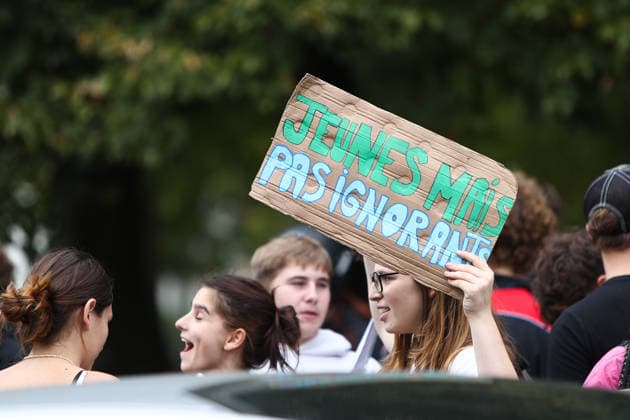October 2, 2026, Bayonne, Nouvelle Aquitaine, France: A young protester holds up a cardboard sign reading Young but not ignorant during a demonstration in Bayonne, southwestern France, on October 2, 2026, against overcrowded classes and a lack of resources. The movement, which began in the Paris region a week ago, has spread across France, with hundreds of high schools blocked. Bayonne France - ZUMAb298 20261002_zsp_b298_001 Copyright: xJulesxBuonx