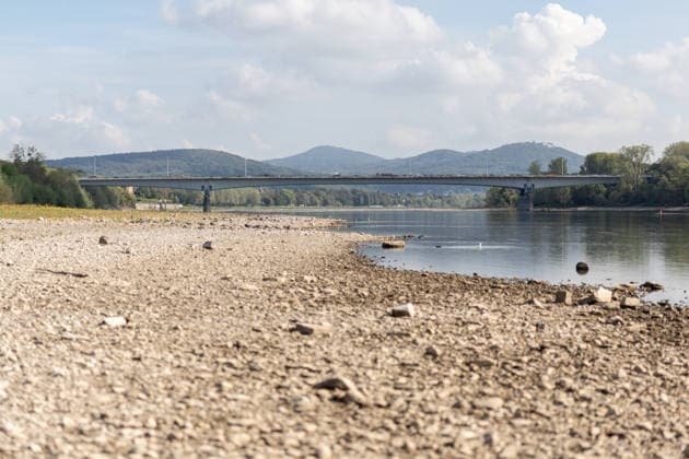 Niedrigwasser am Rhein in Bonn - 02.10.26 Nach den jüngsten Regenfällen steigt der Pegel Bonn wieder leicht an und liegt bei 64 cm nur wenig über dem Rekordtief von 58 cm vom 29. September. Am Beueler Rheinufer liegt der alte Bootsslip der DLRG Bonn trocken. Im Hintergrund die Südbrücke A562 und das Siebengebirge Bonn Beuel Nordrhein-Westfalen Deutschland Copyright: xMarcxJohnx