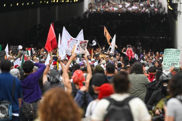 October 2, 2026: TO-45322-MEXICO , October 2, 2026. Student leaders from 1968 marched alongside students from various public universities, feminist collectives, "searching mothers," and Indigenous people from diverse regions to commemorate the anniversary of the Tlatelolco Massacre. They chanted slogans such as "No forgiveness, no forgetting," "Death to the State," and "It was the military." They marched along various avenues in the Mexican capital, concluding their rally at the Z& xf3;calo plaza, where clashes broke out with police stationed behind the barriers guarding the National Palace. In Mexico City. Clasos.com.mx - ZUMAcs4_ 20261002_faa_cs4_216 Copyright: xJavierxLiraxOterox