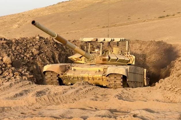 TAJIKISTAN - OCTOBER 3, 2026: Russian tank crews destroy a simulated enemy during the Tsentr Centre 2026 military exercise held at the Lyaur training ground. Video screen grab. Best quality available. Russian Defence Ministry TASS  98708959