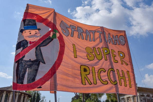October 3, 2026, Rome, Rome, Italy: Demonstrators hold a banner calling to evict the super-rich during the Potere al Popolo demonstration at Piazza Bocca della VeritÃ in Rome on October 3, 2026. Rome Italy - ZUMAn299 20261003_zip_n299_001 Copyright: xVincenzoxNuzzolesex