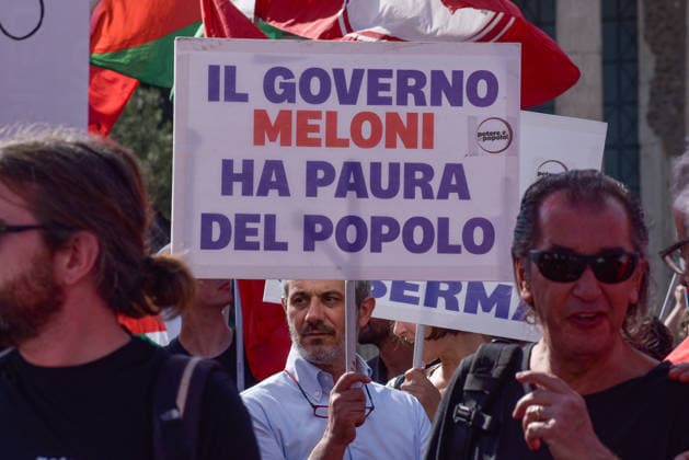 October 3, 2026, Rome, Rome, Italy: A protester holds a sign against the policies of the Meloni government during the Potere al Popolo demonstration at Piazza Bocca della VeritÃ in Rome on October 3, 2026. Rome Italy - ZUMAn299 20261003_zip_n299_004 Copyright: xVincenzoxNuzzolesex