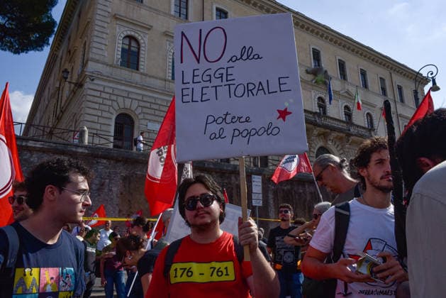 October 3, 2026, Rome, Rome, Italy: A protester holds a sign against the electoral law during the Potere al Popolo demonstration at Piazza Bocca della VeritÃ in Rome on October 3, 2026. Rome Italy - ZUMAn299 20261003_zip_n299_005 Copyright: xVincenzoxNuzzolesex