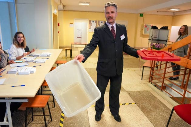 October 3, 2026, Riga, LATVIA: A man demonstrates an empty ballot box at a polling station during the parliamentary elections in Riga, Latvia, Oct. 3, 2026. Riga LATVIA  - ZUMAp305 20261003_zip_p305_003 Copyright: xEdijsxPalensx