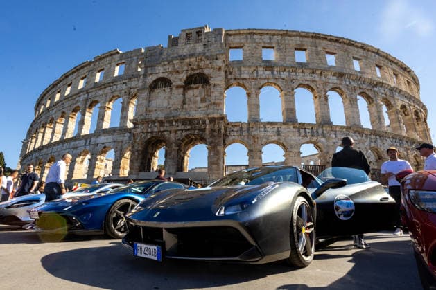 Ferrari Tour stops in Pula Luxury Ferrari sports cars taking part in a Ferrari Tour organized by Ineco Auto, are seen in front of the Roman Arena in Pula, Croatia, on October 3, 2026. While the drivers visit the ancient amphitheatre, local residents gather to watch and admire the vehicles.  SreckoxNiketic PIXSELL