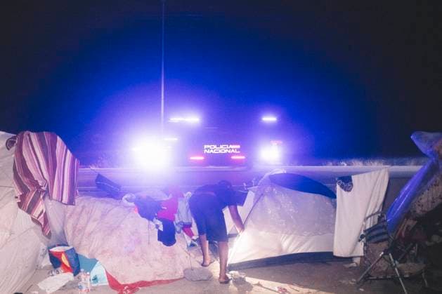 October 3, 2026, Ceuta, Ceuta, Spain: The lights of a police van shine behind a tent at a makeshift migrant camp in Ceuta at night. Riot police escorted firefighters through the camp on the night of October 3 to put out the fires that people living there use to cook their food. Thousands of migrants, most of them young Moroccan men, have been living in makeshift settlements in the Spanish North African enclave of Ceuta since a mass arrival at the end of July 2026 set off a migration and political crisis. Ceuta Spain - ZUMAs392 20261003_zip_s392_007 Copyright: xFabianxSuspensivox