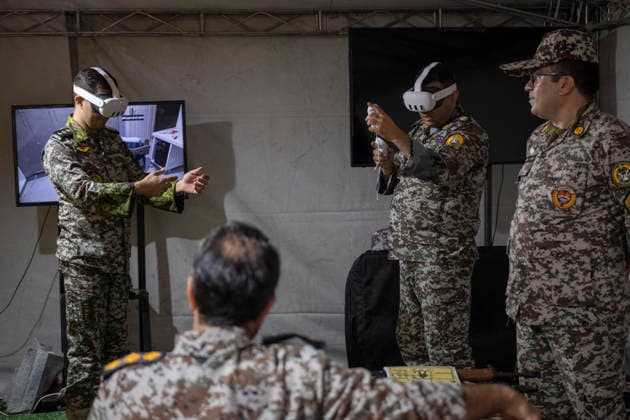 Opening Ceremony Of Second City-Square Military Training Camp Iranian Army servicemen wear virtual reality headsets to shoot with virtual rifles during the opening ceremony of the second city-square military training camp for self-sacrificing forces in downtown Tehran, Iran, on October 3, 2026. The camp was established by the Basij paramilitary force, with personnel from the Islamic Republic of Iran Army responsible for training the volunteers. Tehran Tehran Iran  Copyright: xMortezaxNikoubazlx originalFilename: nikoubazl-openingc261003_np2gu.jpg