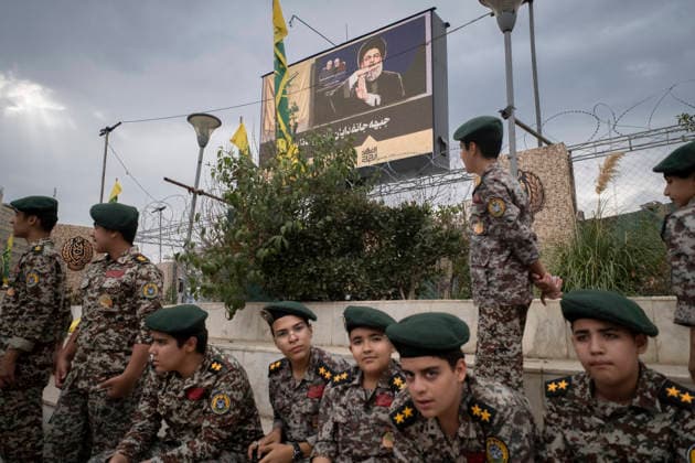 Opening Ceremony Of Second City-Square Military Training Camp Iranian schoolboys wearing military uniforms gather beneath a portrait of Hassan Nasrallah, the late secretary general of Lebanon s Hezbollah, as they prepare to take part in the opening ceremony of the second city-square military training camp for self-sacrificing forces in downtown Tehran, Iran, on October 3, 2026. The camp was established by the Basij paramilitary force, with personnel from the Islamic Republic of Iran Army responsible for training the volunteers. Tehran Tehran Iran  Copyright: xMortezaxNikoubazlx originalFilename: nikoubazl-openingc261003_np5QQ.jpg