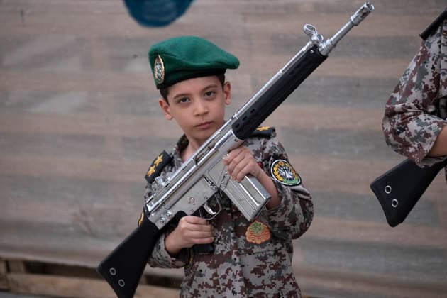 Opening Ceremony Of Second City-Square Military Training Camp An Iranian schoolboy wearing an Iranian Army military uniform holds a rifle while taking part in the opening ceremony of the second city-square military training camp for self-sacrificing forces in downtown Tehran, Iran, on October 3, 2026. The camp was established by the Basij paramilitary force, with personnel from the Islamic Republic of Iran Army responsible for training the volunteers. Tehran Tehran Iran  Copyright: xMortezaxNikoubazlx originalFilename: nikoubazl-openingc261003_npA2r.jpg