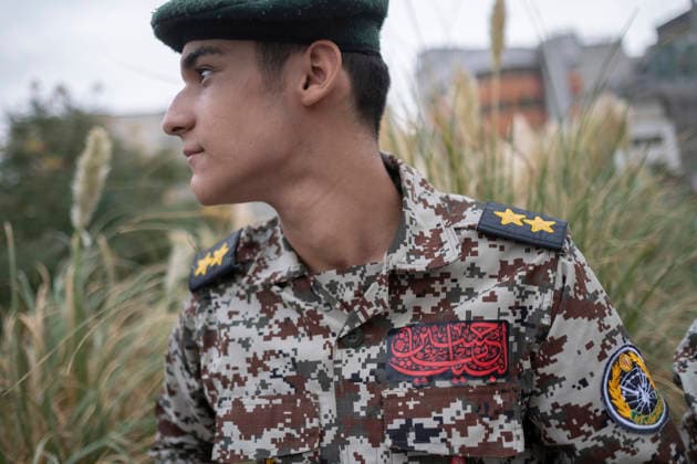Opening Ceremony Of Second City-Square Military Training Camp An Iranian schoolboy wearing an Iranian Army military uniform looks on while preparing to take part in the opening ceremony of the second city-square military training camp for self-sacrificing forces in downtown Tehran, Iran, on October 3, 2026. The camp was established by the Basij paramilitary force, with personnel from the Islamic Republic of Iran Army responsible for training the volunteers. Tehran Tehran Iran  Copyright: xMortezaxNikoubazlx originalFilename: nikoubazl-openingc261003_npFBW.jpg