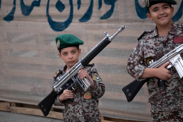 Opening Ceremony Of Second City-Square Military Training Camp Two Iranian schoolboys wearing military uniforms hold rifles during the opening ceremony of the second city-square military training camp for self-sacrificing forces in downtown Tehran, Iran, on October 3, 2026. The camp was established by the Basij paramilitary force, with personnel from the Islamic Republic of Iran Army responsible for training the volunteers. Tehran Tehran Iran  Copyright: xMortezaxNikoubazlx originalFilename: nikoubazl-openingc261003_npIPT.jpg