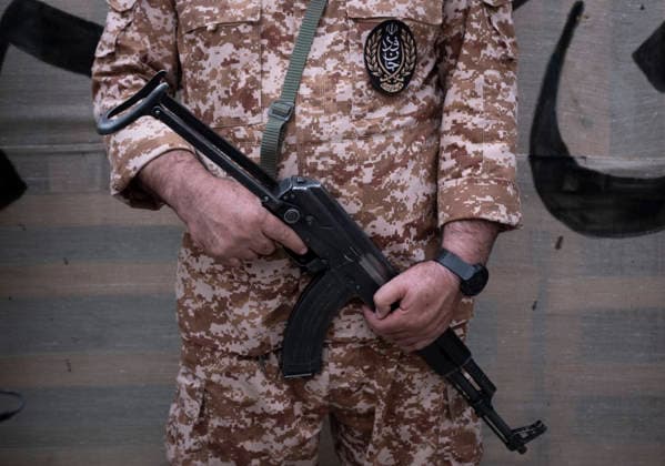 Opening Ceremony Of Second City-Square Military Training Camp A member of the Islamic Revolutionary Guard Corps (IRGC) attaches a badge for self-sacrificing forces to his uniform while holding a rifle and standing guard during the opening ceremony of the second city-square military training camp in downtown Tehran, Iran, on October 3, 2026. The camp was established by the Basij paramilitary force, with personnel from the Islamic Republic of Iran Army responsible for training the volunteers. Tehran Tehran Iran  Copyright: xMortezaxNikoubazlx originalFilename: nikoubazl-openingc261003_npNwq.jpg