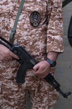 Opening Ceremony Of Second City-Square Military Training Camp A member of the Islamic Revolutionary Guard Corps (IRGC) attaches a badge for self-sacrificing forces to his uniform while holding a rifle and standing guard during the opening ceremony of the second city-square military training camp in downtown Tehran, Iran, on October 3, 2026. The camp was established by the Basij paramilitary force, with personnel from the Islamic Republic of Iran Army responsible for training the volunteers. Tehran Tehran Iran  Copyright: xMortezaxNikoubazlx originalFilename: nikoubazl-openingc261003_npXnf.jpg