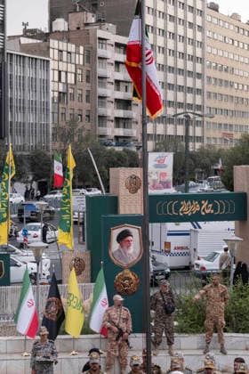 Opening Ceremony Of Second City-Square Military Training Camp An armed member of the Basij paramilitary forces stands at attention beneath an Iranian national flag during the opening ceremony of the second city-square military training camp for self-sacrificing forces in downtown Tehran, Iran, on October 3, 2026. The camp was established by the Basij paramilitary force, with personnel from the Islamic Republic of Iran Army responsible for training the volunteers. Tehran Tehran Iran  Copyright: xMortezaxNikoubazlx originalFilename: nikoubazl-openingc261003_npZFO.jpg