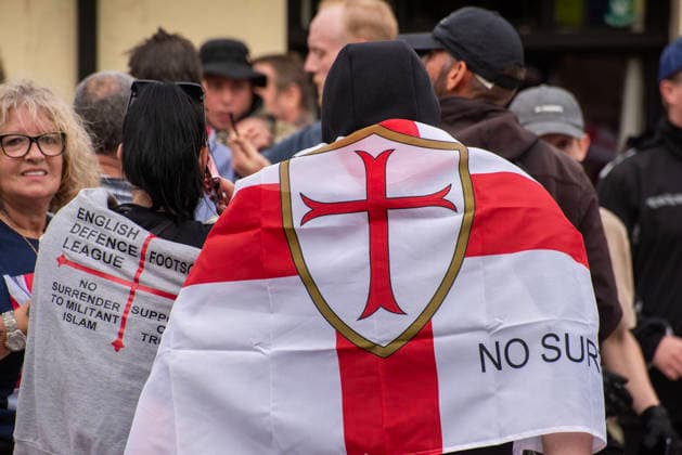 October 3, 2026, Dover, United Kingdom: A couple wrapped in St George s flags during a demonstration in Dover. Supporters of the English Defence League (EDL) gathered in Dover, UK to march through the town all the way to the harbour. English Defence League is an extreme far-right and Islamophobic organisation. It was founded by Tommy Robinson (pseudonym of Steven Yaxley-Lennon) in 2009. Dover United Kingdom - ZUMAs197 20261003_aaa_s197_253 Copyright: xKrisztianxElekx