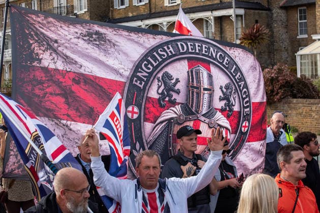 October 3, 2026, Dover, United Kingdom: Far-right protesters march with banner and flags to the harbour during a demonstration in Dover. Supporters of the English Defence League (EDL) gathered in Dover, UK to march through the town all the way to the harbour. English Defence League is an extreme far-right and Islamophobic organisation. It was founded by Tommy Robinson (pseudonym of Steven Yaxley-Lennon) in 2009. Dover United Kingdom - ZUMAs197 20261003_aaa_s197_260 Copyright: xKrisztianxElekx