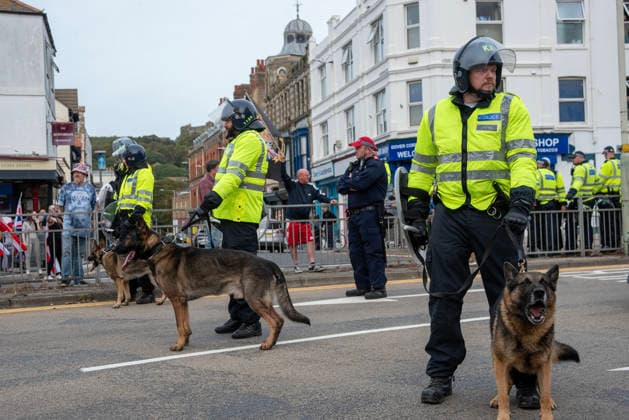 October 3, 2026, Dover, United Kingdom: Members of the police dog unit with their German Shepherds keep clear the road during a demonstration in Dover. Supporters of the English Defence League (EDL) gathered in Dover, UK to march through the town all the way to the harbour. English Defence League is an extreme far-right and Islamophobic organisation. It was founded by Tommy Robinson (pseudonym of Steven Yaxley-Lennon) in 2009. Dover United Kingdom - ZUMAs197 20261003_aaa_s197_262 Copyright: xKrisztianxElekx