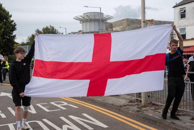 October 3, 2026, Dover, United Kingdom: Far-right protesters hold a St George s flag during a demonstration in Dover. Supporters of the English Defence League (EDL) gathered in Dover, UK to march through the town all the way to the harbour. English Defence League is an extreme far-right and Islamophobic organisation. It was founded by Tommy Robinson (pseudonym of Steven Yaxley-Lennon) in 2009. Dover United Kingdom - ZUMAs197 20261003_aaa_s197_263 Copyright: xKrisztianxElekx