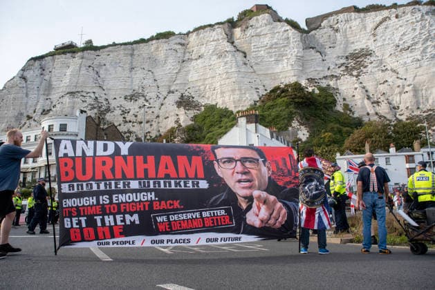 October 3, 2026, Dover, United Kingdom: Far-right protesters hold a banner with a photo of the UK Prime Minister, Andy Burnham during a demonstration in Dover. Supporters of the English Defence League (EDL) gathered in Dover, UK to march through the town all the way to the harbour. English Defence League is an extreme far-right and Islamophobic organisation. It was founded by Tommy Robinson (pseudonym of Steven Yaxley-Lennon) in 2009. Dover United Kingdom - ZUMAs197 20261003_aaa_s197_266 Copyright: xKrisztianxElekx