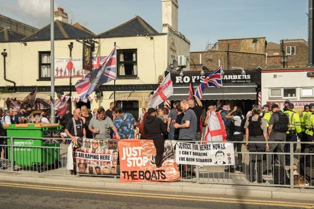 October 3, 2026, Dover, United Kingdom of Great Britain and Northern Ireland: DOVER, UNITED KINGDOM, OCTOBER 3, 2026: Anti-immigration protesters and anti-racism counter-protesters gather during rival demonstrations in Dover, Kent. Anti-immigration demonstrators carrying Union flags and St George s flags displayed banners calling for deportations and an end to small-boat crossings, while counter-protesters gathered nearby. Police maintained a significant presence between the groups and monitored the demonstrations. Dover United Kingdom of Great Britain and Northern Ireland - ZUMAq101 20261003_zna_q101_206 Copyright: xMarcxLewisx