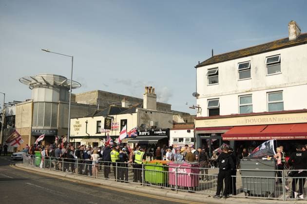 October 3, 2026, Dover, United Kingdom of Great Britain and Northern Ireland: DOVER, UNITED KINGDOM, OCTOBER 3, 2026: Anti-immigration protesters and anti-racism counter-protesters gather during rival demonstrations in Dover, Kent. Anti-immigration demonstrators carrying Union flags and St George s flags displayed banners calling for deportations and an end to small-boat crossings, while counter-protesters gathered nearby. Police maintained a significant presence between the groups and monitored the demonstrations. Dover United Kingdom of Great Britain and Northern Ireland - ZUMAq101 20261003_zna_q101_211 Copyright: xMarcxLewisx