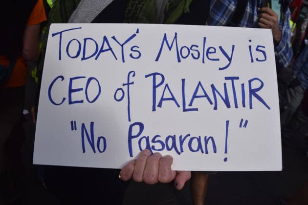 October 4, 2026, London, England, United Kingdom: A protester holds a sign comparing the CEO of Palantir to Oswald Mosley during the march to Cable Street against racism and fascism, marking the 90th anniversary since the Battle of Cable Street. London United Kingdom  - ZUMAv130 20261004_zip_v130_003 Copyright: xVukxValcicx