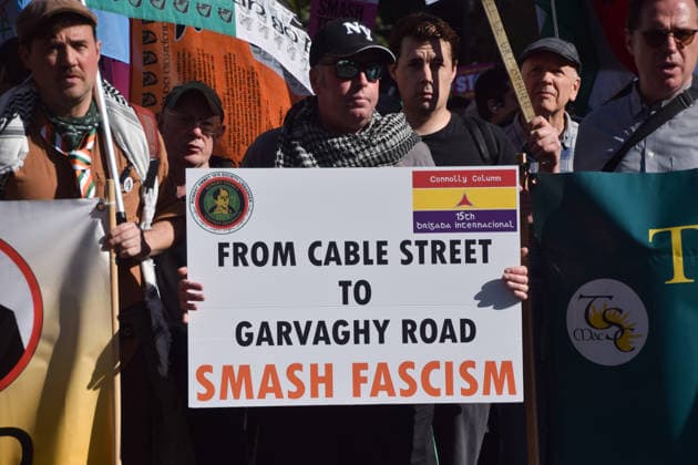 October 4, 2026, London, England, United Kingdom: A protester holds a sign stating From Cable Street to Garvaghy Road during the march to Cable Street against racism and fascism, marking the 90th anniversary since the Battle of Cable Street. London United Kingdom  - ZUMAv130 20261004_zip_v130_019 Copyright: xVukxValcicx