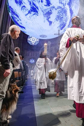 October 4, 2026, New York, New York, United States: A dog looks towards the incense as Cathedral clergy process beneath Gaia, the monumental illuminated Earth installation by British artist LUKE JERRAM, during the Blessing of the Earth and Animals at the Cathedral of St. John the Divine in New York. New York United States  - ZUMAo116 20261004_znp_o116_024 Copyright: xBiancaxOterox