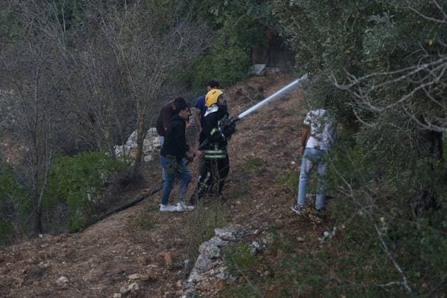 Israeli Settlers Set Fire To Olive Trees And Car Scrap Yard Near Ein Yabrud EIN YABRUD, WEST BANK, PALESTINE OCTOBER 4, 2026: Israeli settlers set fire to olive trees and a car scrap yard between the villages of Ein Yabrud and Silwad, northeast of Ramallah, in the occupied West Bank, on October 4, 2026. The owner of the yard said more than 50 cars were destroyed in the fire. The incident occurred amid ongoing attacks targeting Palestinian property and agricultural land in the area. Fires affecting olive trees and other Palestinian property have also been reported in areas around Silwad. Ramallah Palestine, State of Copyright: x xSalmanxMohsenxAlkhatibx xJNAxPressx