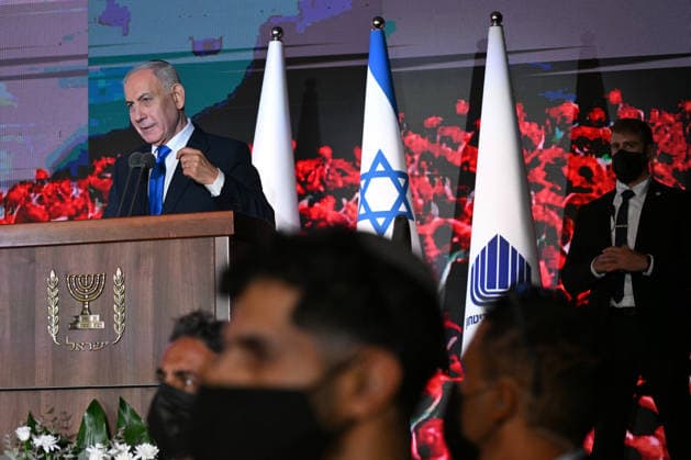 Security surrounds Israeli Prime Minister Benjamin Netanyahu as he speaks at the State Memorial Ceremony for the three year anniversary of the October 7, 2023, Hamas attack, in remembrance of Israel Defense Forces and security members who fell in the War of Redemption in the Mt. Herzl Cemetery, Jerusalem, on Monday, October 5, 2026.  JER2026100504 DEBBIExHILL
