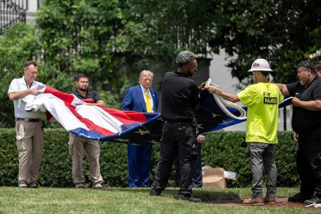 October 5, 2026, Washington, Dc, United States of America: U.S. President Donald Trump watches as workers unfurl an American flag to be raised on a newly installed flagpole on the South Lawn of the White House, June 18, 2025 in Washington, D.C. The flag was raised on one of two new flagpoles Trump had installed on the North and South Lawns of the White House, which he said he paid for personally. Washington United States of America - ZUMAp138 20261005_zaa_p138_085 Copyright: xMollyxRiley WhitexHousex