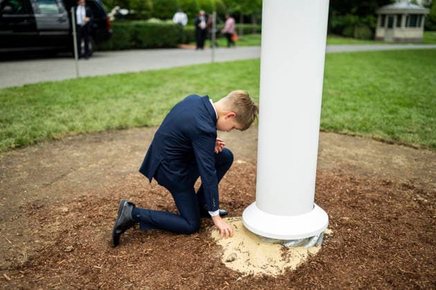 October 5, 2026, Washington, Dc, United States of America: A grandson of U.S. President Donald Trump picks up sand at the base of the newly installed flagpole on the South Lawn of the White House, June 18, 2025 in Washington, D.C. The flag was raised on one of two new flagpoles Trump had installed on the North and South Lawns of the White House, which he said he paid for personally. Washington United States of America - ZUMAp138 20261005_zaa_p138_081 Copyright: xDanielxTorok WhitexHousex