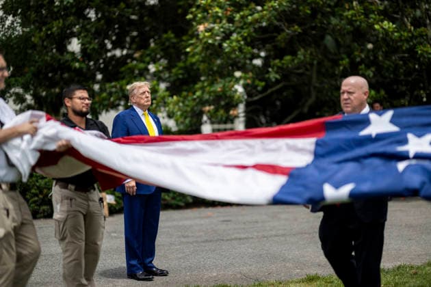 October 5, 2026, Washington, Dc, United States of America: U.S. President Donald Trump watches as workers unfurl an American flag to be raised on a newly installed flagpole on the South Lawn of the White House, June 18, 2025 in Washington, D.C. The flag was raised on one of two new flagpoles Trump had installed on the North and South Lawns of the White House, which he said he paid for personally. Washington United States of America - ZUMAp138 20261005_zaa_p138_043 Copyright: xDanielxTorok WhitexHousex