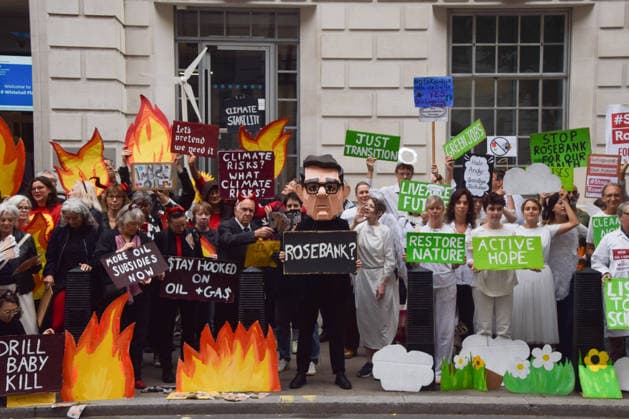 October 6, 2026, London, England, United Kingdom: Activists from the group Fossil Free London stage a protest against the Rosebank oil field and the Jackdaw gas field outside the Department for Energy Security and Net Zero. Activists dressed as angels urge a protester wearing an Andy Burnham mask to stop the fossil fuel projects in the North Sea while activists dressed as demons urge him to drill for more oil. London United Kingdom  - ZUMAv130 20261006_zip_v130_002 Copyright: xVukxValcicx