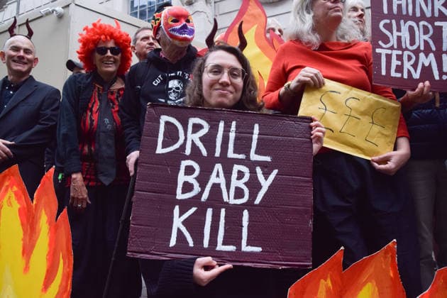 October 6, 2026, London, England, United Kingdom: Activists from the climate action group Fossil Free London staged a protest against the Rosebank oil field and the Jackdaw gas field outside the Department for Energy Security and Net Zero. Activists dressed as angels urged a protester wearing an Andy Burnham mask to stop the fossil fuel projects in the North Sea while activists dressed as demons urged him to drill for more oil. London United Kingdom  - ZUMAv130 20261006_zip_v130_014 Copyright: xVukxValcicx