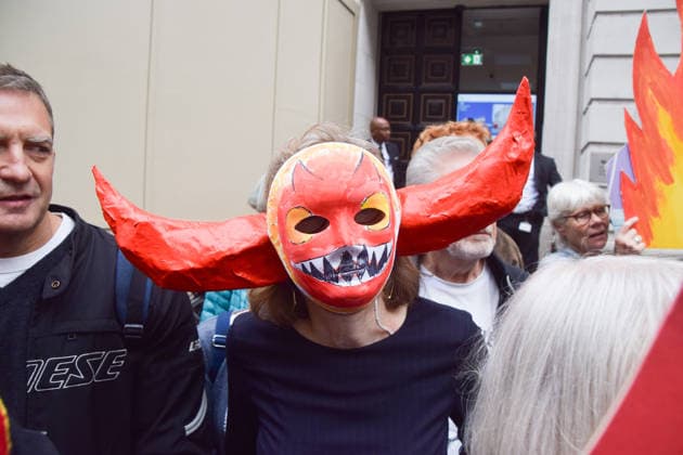 October 6, 2026, London, England, United Kingdom: Activists from the climate action group Fossil Free London staged a protest against the Rosebank oil field and the Jackdaw gas field outside the Department for Energy Security and Net Zero. Activists dressed as angels urged a protester wearing an Andy Burnham mask to stop the fossil fuel projects in the North Sea while activists dressed as demons urged him to drill for more oil. London United Kingdom  - ZUMAv130 20261006_zip_v130_018 Copyright: xVukxValcicx