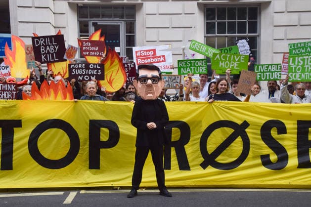 October 6, 2026, London, England, United Kingdom: Activists from the climate action group Fossil Free London stage a protest against the Rosebank oil field and the Jackdaw gas field outside the Department for Energy Security and Net Zero. Activists dressed as angels urge a protester wearing an Andy Burnham mask to stop the fossil fuel projects in the North Sea while activists dressed as demons urge him to drill for more oil. London United Kingdom  - ZUMAv130 20261006_zip_v130_033 Copyright: xVukxValcicx