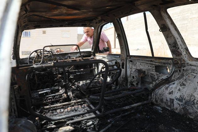 Palestinian Inspects Burned Vehicles Near al-Samu South of Hebron A Palestinian man inspects his burned vehicles near the town of al-Samu, south of Hebron, in the West Bank, on October 6, 2026, after an apparent arson attack believed to have been carried out by Israeli settlers. The incident comes amid an increase in settler attacks on Palestinians and their property in different areas of the West Bank. Photo by Mamoun Wazwaz apaimages Hebron West Bank Palestinian Territory 061026_Hebron_MW_00(9) Copyright: xapaimagesxMamounxWazwazx xapaimagesx