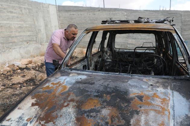 Palestinian Inspects Burned Vehicles Near al-Samu South of Hebron A Palestinian man inspects his burned vehicles near the town of al-Samu, south of Hebron, in the West Bank, on October 6, 2026, after an apparent arson attack believed to have been carried out by Israeli settlers. The incident comes amid an increase in settler attacks on Palestinians and their property in different areas of the West Bank. Photo by Mamoun Wazwaz apaimages Hebron West Bank Palestinian Territory 061026_Hebron_MW_00(8) Copyright: xapaimagesxMamounxWazwazx xapaimagesx
