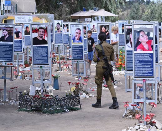 An Israeli soldier walks past photos of hundreds of victims killed by Hamas on October 7, 2023, at the Nova Festival Memorial site in Re im, near the Gaza border on Monday, October 6, 2026. Israel is marking three years since the Hamas attack that killed 1,200 people and 251 were taken hostage into Gaza.  JER2026100613 DEBBIExHILL