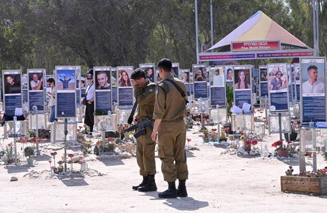 An Israeli soldier mourns near photos of hundreds of victims killed by Hamas on October 7, 2023, at the Nova Festival Memorial site in Re im, near the Gaza border on Monday, October 6, 2026. Israel is marking three years since the Hamas attack that killed 1,200 people and 251 were taken hostage into Gaza.  JER2026100616 DEBBIExHILL