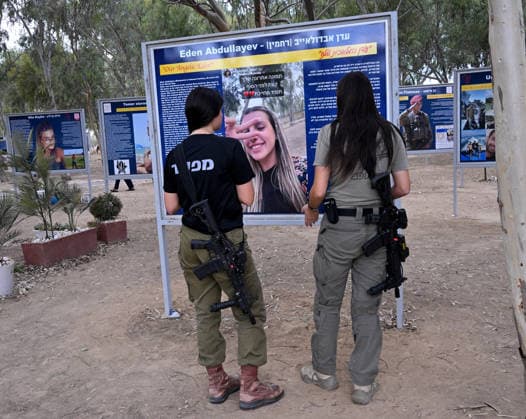 Israeli soldiers look at a photo of a victim killed by Hamas on October 7, 2023, at the Nova Festival Memorial site in Re im, near the Gaza border on Monday, October 6, 2026. Israel is marking three years since the Hamas attack that killed 1,200 people and 251 were taken hostage into Gaza.  JER2026100618 DEBBIExHILL