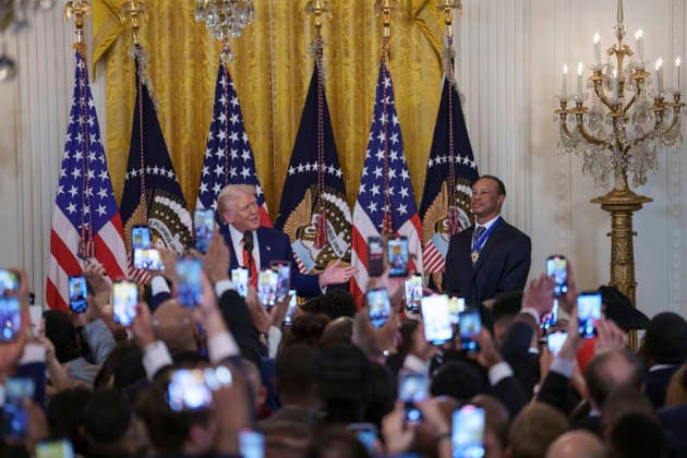 October 6, 2026, Washington, Dc, United States of America: Guests take photos using their phones as U.S. President Donald Trump and golfer Tiger Woods appear at a reception honoring Black History Month in the East Room of the White House, February 20, 2025 in Washington, D.C. Trump introduced golfer Tiger Woods as a surprise guest at the reception in the East Room, where he praised Woods as one of the greatest athletes of all time. Washington United States of America - ZUMAp138 20261006_zaa_p138_008 Copyright: xJoycexBoghosian WhitexHousex