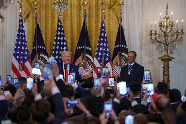 October 6, 2026, Washington, Dc, United States of America: Guests raise their phones as U.S. President Donald Trump and golfer Tiger Woods appear at a reception honoring Black History Month in the East Room of the White House, February 20, 2025 in Washington, D.C. Trump introduced golfer Tiger Woods as a surprise guest at the reception in the East Room, where he praised Woods as one of the greatest athletes of all time. Washington United States of America - ZUMAp138 20261006_zaa_p138_021 Copyright: xJoycexBoghosian WhitexHousex