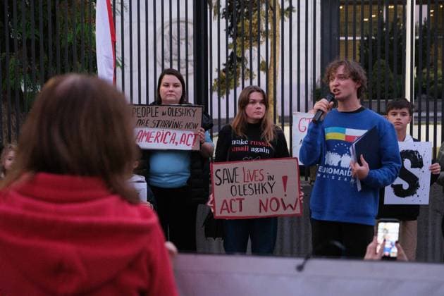 October 6, 2026, Warsaw, Masovian Voivodeship, Poland: A protester speaks as others hold placards calling for international humanitarian action during a demonstration outside the US Embassy in Warsaw protesting the humanitarian crisis in Russian-occupied Oleshky. The protest was organized by Poland s Ukrainian diaspora as an appeal to Ukraine s international partners to step up diplomatic efforts to support civilians trapped in Oleshky with humanitarian aid and the possibility of evacuation. Warsaw Poland  - ZUMAk204 20261006_zip_k204_008 Copyright: xRomanxKozielx