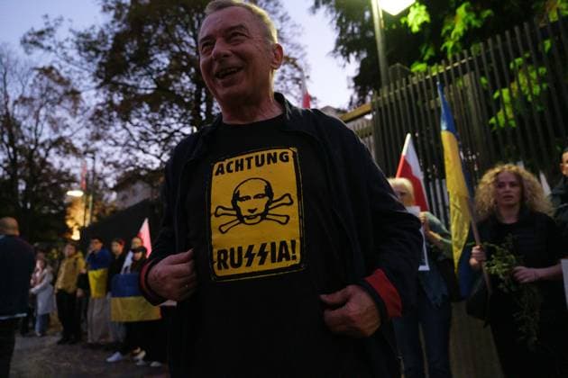 October 6, 2026, Warsaw, Masovian Voivodeship, Poland: A protester wears a shirt bearing the likeness of Vladimir Putin with the words achtung Russia (stylized with SS runes) during a demonstration outside the US Embassy in Warsaw protesting the humanitarian crisis in Russian-occupied Oleshky. The protest was organized by Poland s Ukrainian diaspora as an appeal to Ukraine s international partners to step up diplomatic efforts to support civilians trapped in Oleshky with humanitarian aid and the possibility of evacuation. Warsaw Poland - ZUMAk204 20261006_zip_k204_016 Copyright: xRomanxKozielx