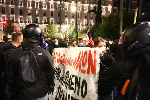 October 6, 2026, Athens, Attica, GREECE: Protesters wearing protective masks hold a banner as they face riot police during an anti-war demonstration opposing the visit of US Secretary of State MARCO RUBIO. Athens GREECE - ZUMAx103 20261006_zip_x103_004 Copyright: xHarrisxXanthopoulosx