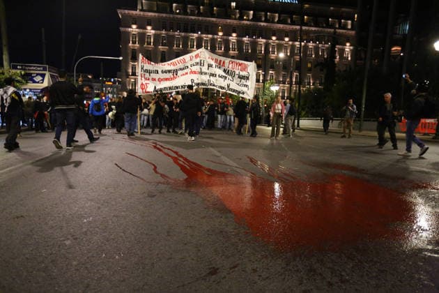 October 6, 2026, Athens, Attica, GREECE: Red paint is spilled onto the street, symbolizing bloodshed in US wars, during an anti-war demonstration opposing the visit of US Secretary of State MARCO RUBIO. Athens GREECE - ZUMAx103 20261006_zip_x103_007 Copyright: xHarrisxXanthopoulosx