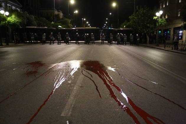 October 6, 2026, Athens, Attica, GREECE: Red paint symbolizing bloodshed in US wars covers the street in front of a police line during an anti-war demonstration opposing the visit of US Secretary of State MARCO RUBIO. Athens GREECE - ZUMAx103 20261006_zip_x103_025 Copyright: xHarrisxXanthopoulosx
